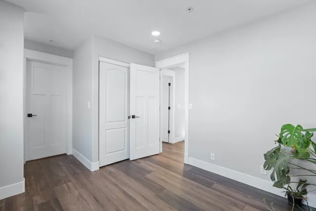 a view of a hallway with wooden floor