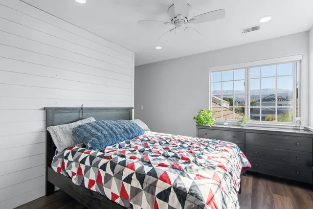 a bedroom with a bed and a window