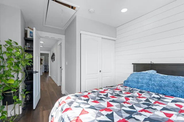 a bedroom with a bed and a potted plant