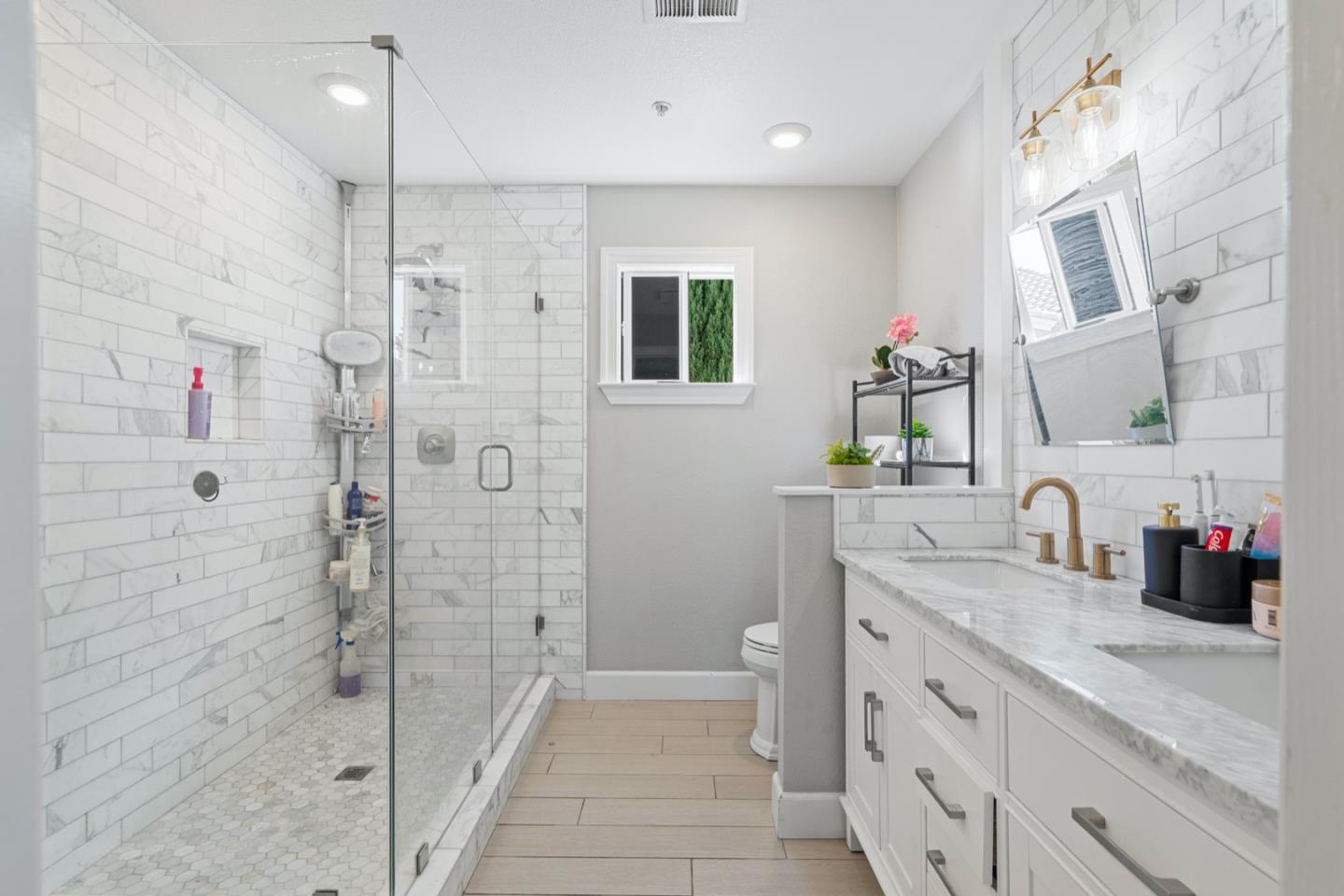 16935 Pine Way Morgan Hill, CA 95037 - Photo 36 of 50 a bathroom with a shower sink and mirror