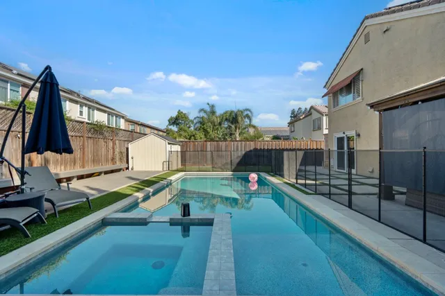 a view of a backyard with sitting area