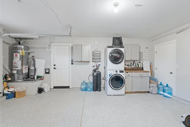 a utility room with sink dryer and washer