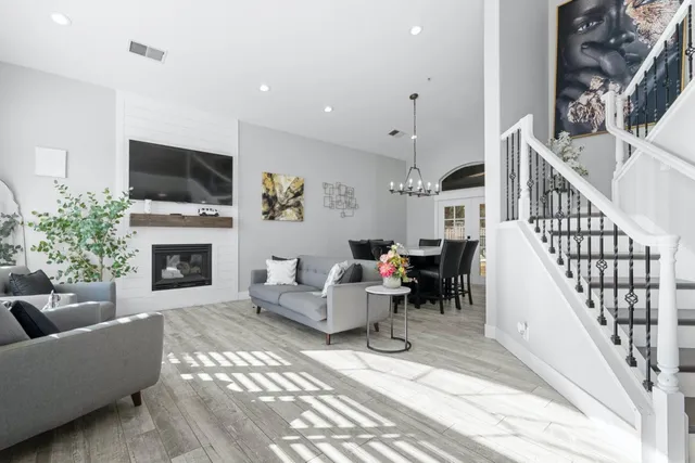 a living room with furniture fireplace and flat screen tv