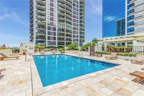 a swimming pool with outdoor seating and yard