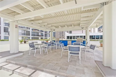 a view of a dining hall with lots of furniture and windows
