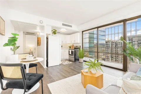 a living room with furniture and a floor to ceiling window