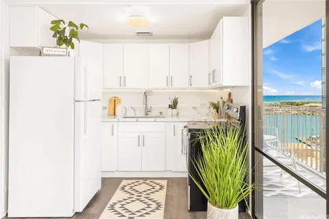 a kitchen with a refrigerator and a sink