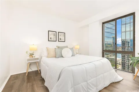 a bedroom with a bed and wooden floor
