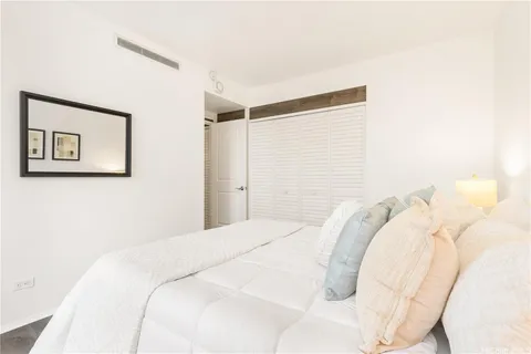 a bedroom with a bed and a painting on the wall