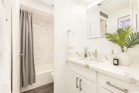 a bathroom with a granite countertop sink a vanity and a mirror