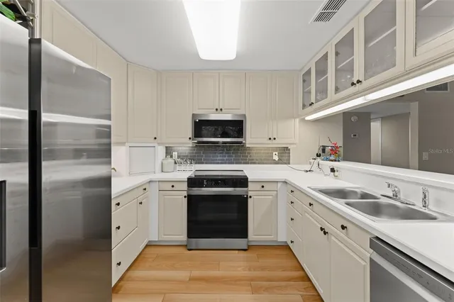 a kitchen with a stove sink and microwave