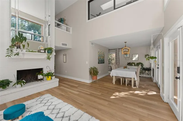 a living room with furniture dining table and a chandelier