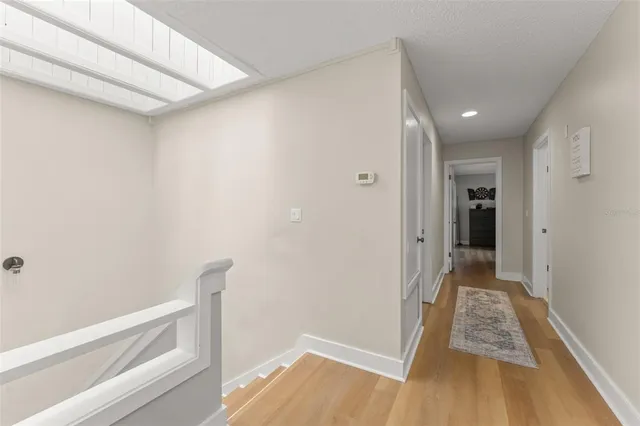 a view of a bedroom with furniture window and wooden floor
