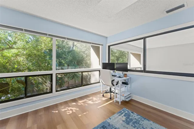 a bathroom with a granite countertop sink a mirror and a shower