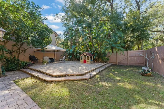 a view of a house with a yard and sitting area
