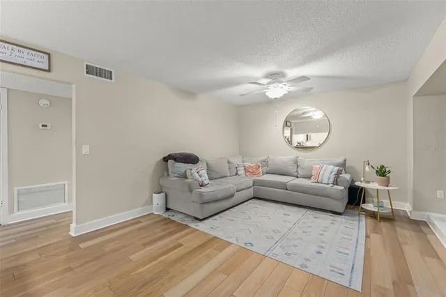a living room with furniture and a wooden floor