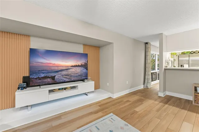 a view of a hallway with wooden floor and closet