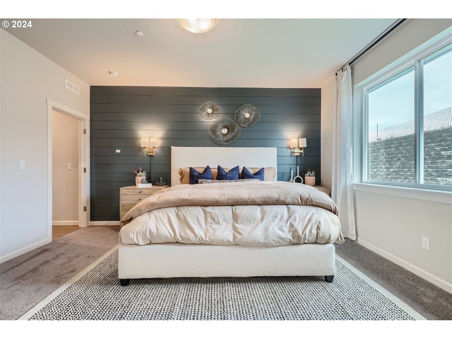 5435 North 87th Avenue Camas, WA 98607 - Photo 11 of 16 a bed sitting in a bedroom next to a window