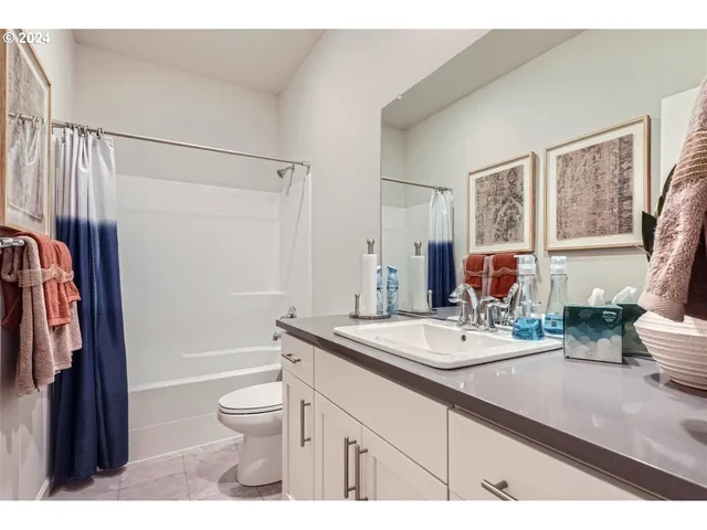 a living room with furniture a large window and a dining table