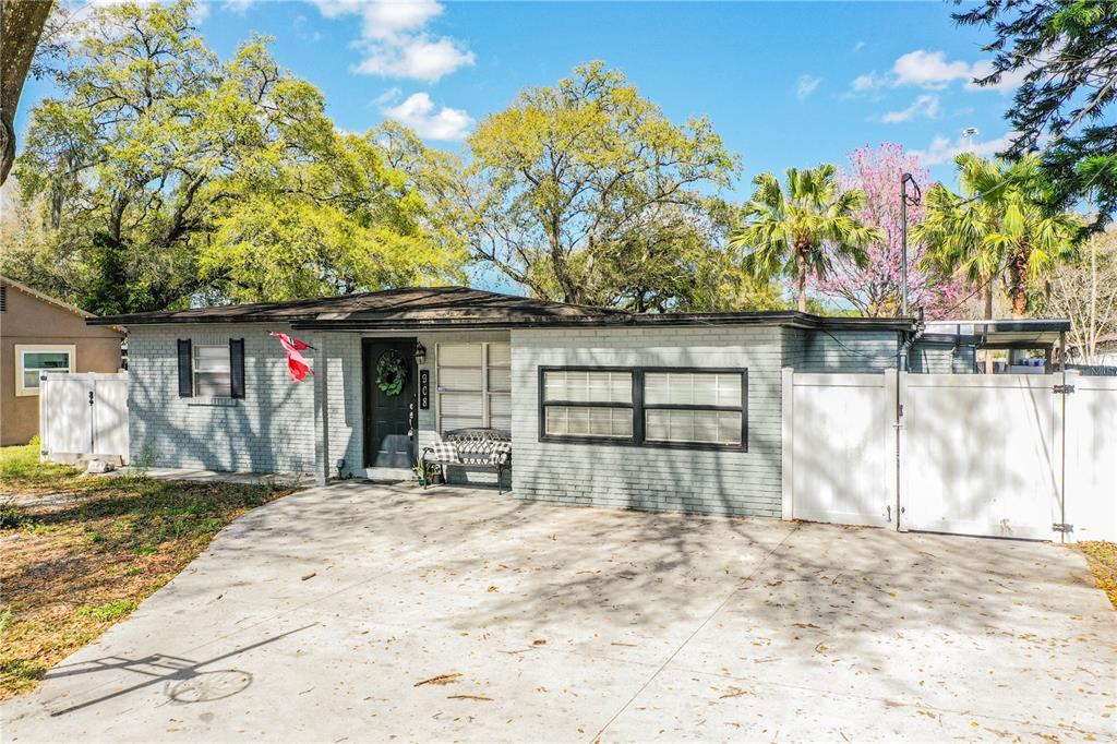 908 Valencia Road Plant City, FL 33563 - Photo 1 of 1 a front view of a house with a yard and garage