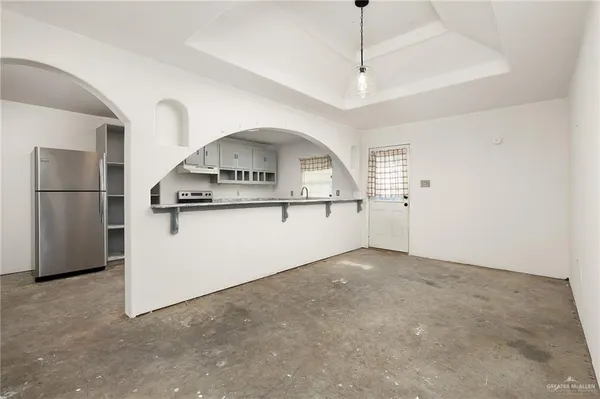 a view of a kitchen with a sink and refrigerator