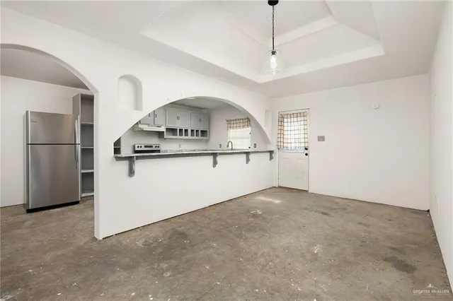 a view of a kitchen with a sink and refrigerator