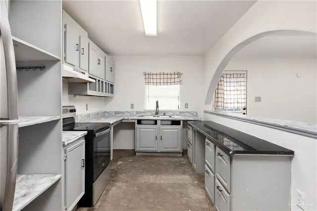 a kitchen with a sink stove and cabinets