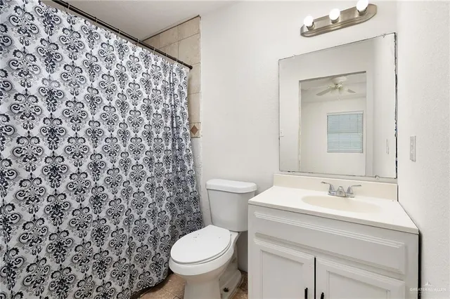a bathroom with a sink toilet and a mirror