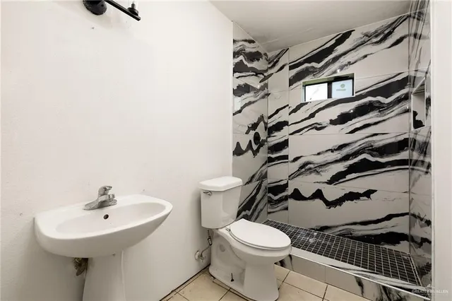 a white toilet sitting next to a bathroom sink