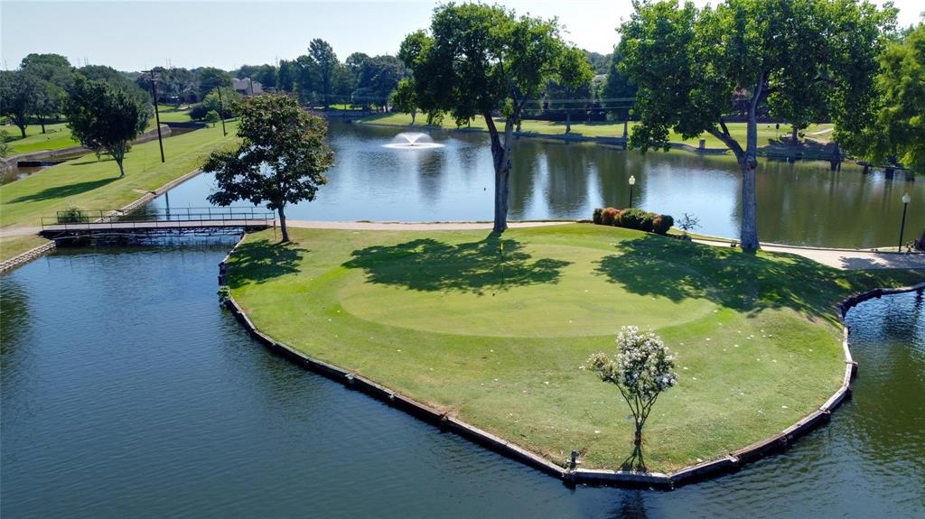 2901 Country Pl Circle Carrollton, TX 75006 - Photo 1 of 37 a view of a swimming pool with a yard and a fountain