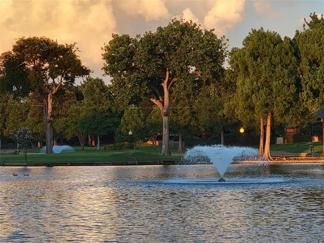 a backyard of a house with lots of green space and trees