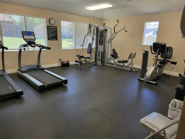 a room with gym equipment and a flat screen tv