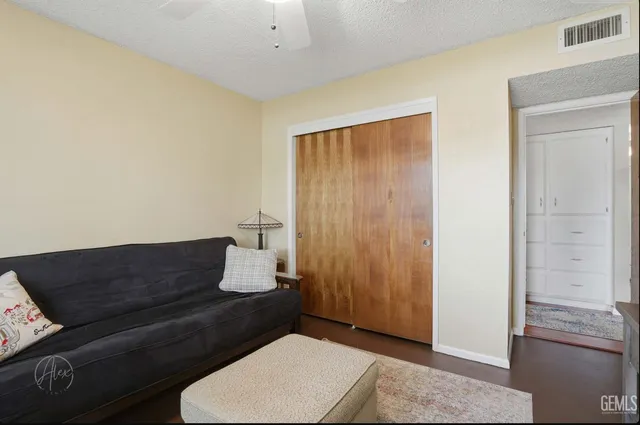 a living room with a couch and a potted plant