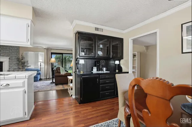 a kitchen with a table chairs refrigerator and cabinets