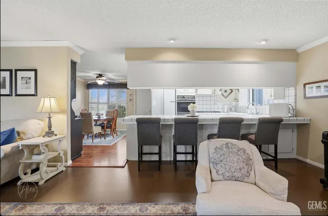 a living room with lots of furniture and view of kitchen