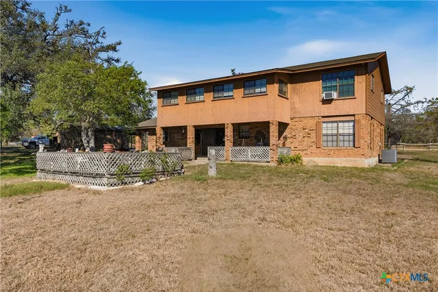 a view of a forest with trees in the background