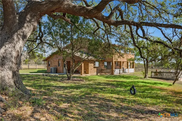 a house view with a sitting space and garden