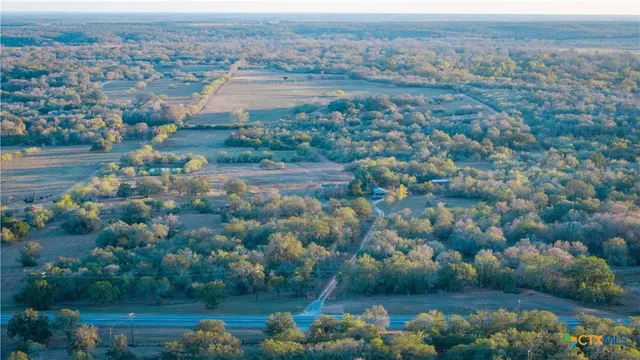 a view of a barn in the middle of a yard