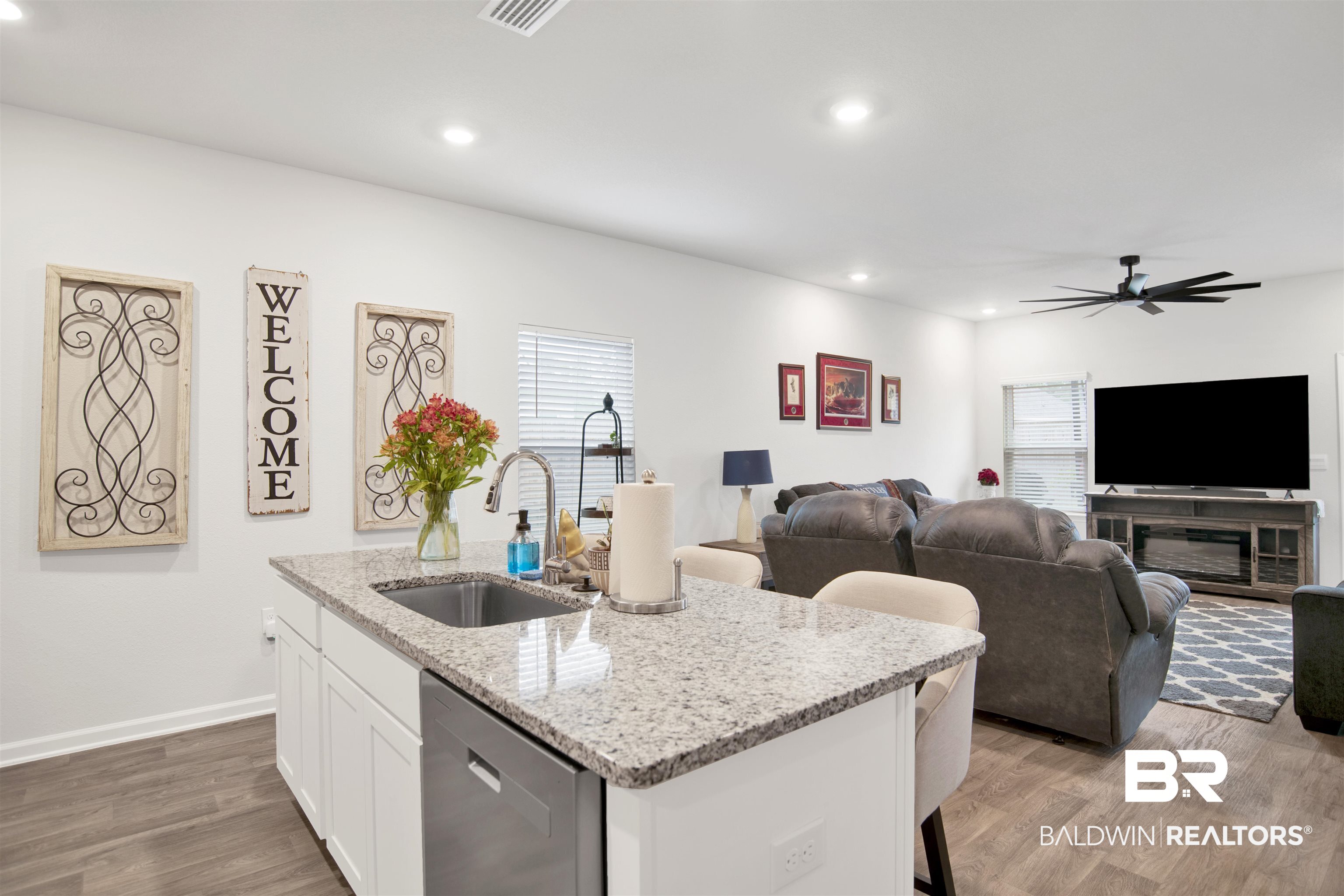 12813 Patriot Way Daphne, AL 36527 - Photo 17 of 23 Kitchen island featuring a stainless steel sink, granite countertop, and integrated dishwasher