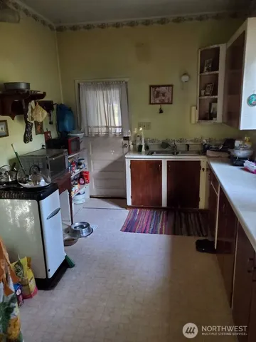 a kitchen with refrigerator and cabinets