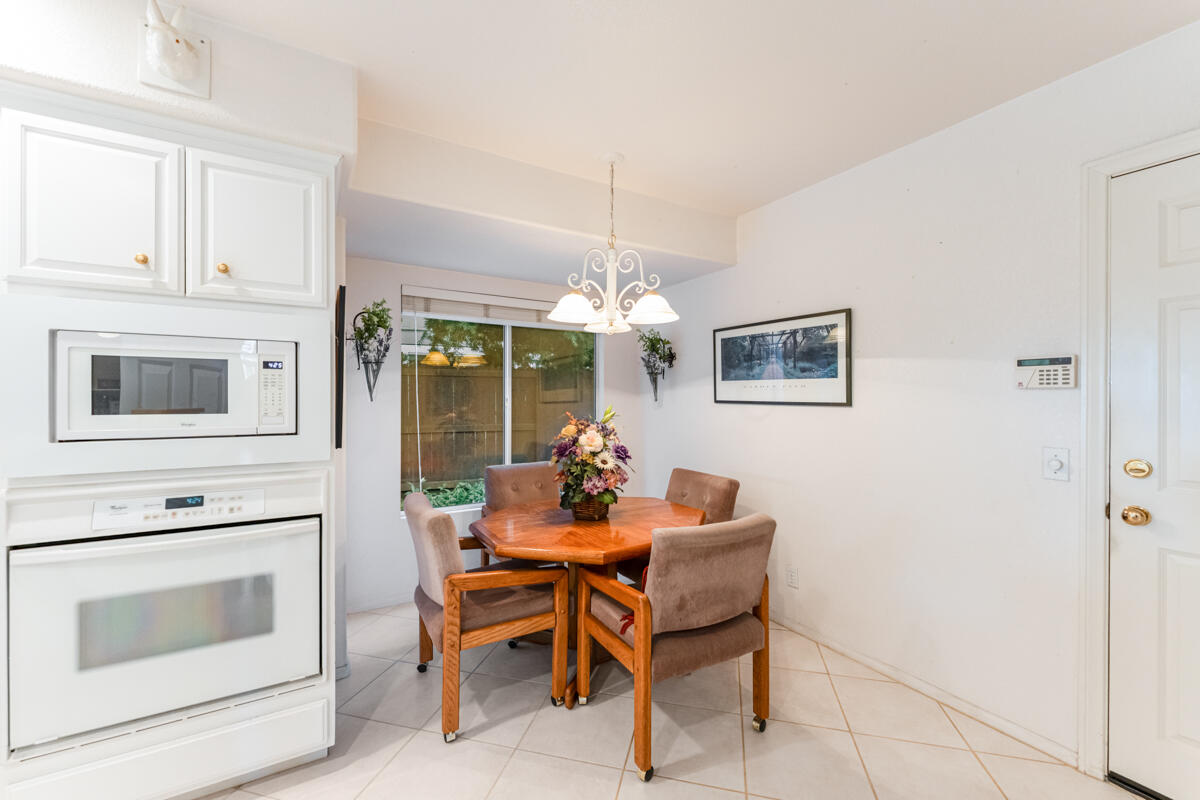 5019 Whitney Court Santa Barbara, CA 93111 - Photo 13 of 34 a dining room with furniture a fireplace and chandelier