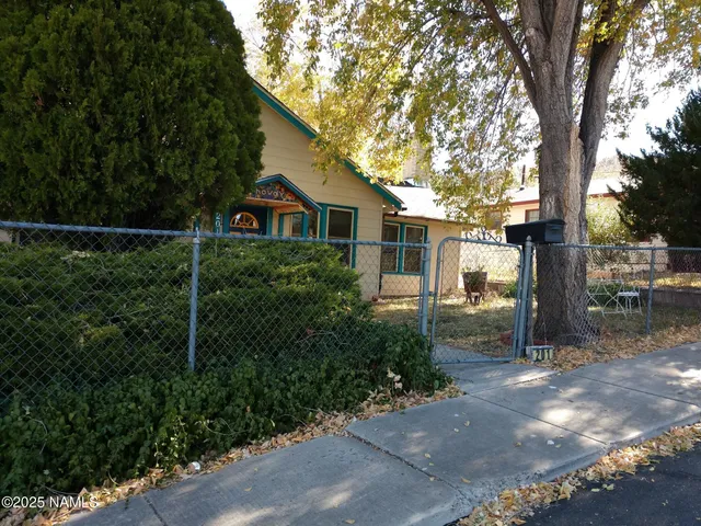 a living room with furniture a fireplace and a large window