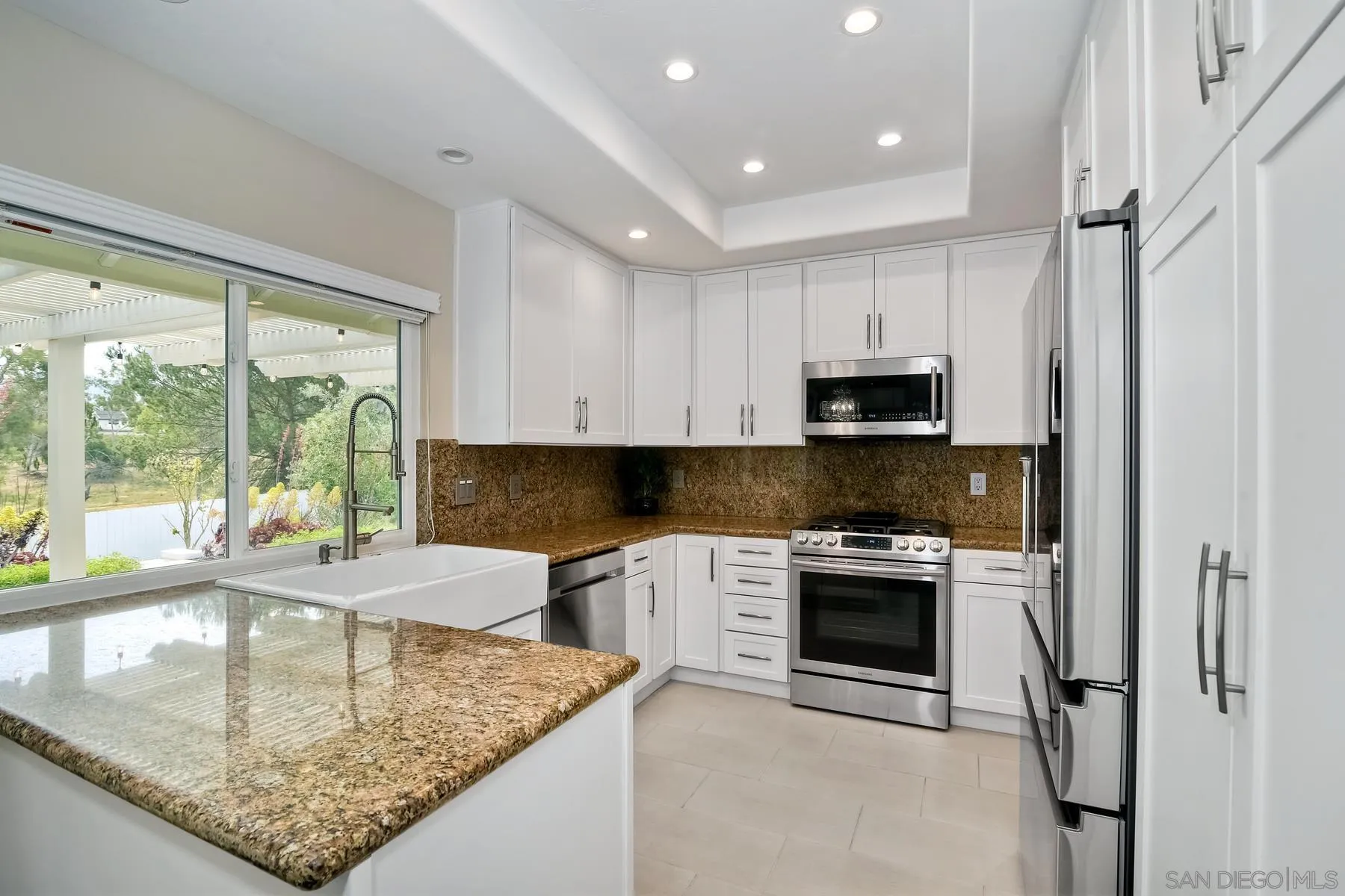 17533 St Andrews Drive Poway, CA 92064 - Photo 23 of 56 a kitchen with stainless steel appliances granite countertop a sink stove and refrigerator