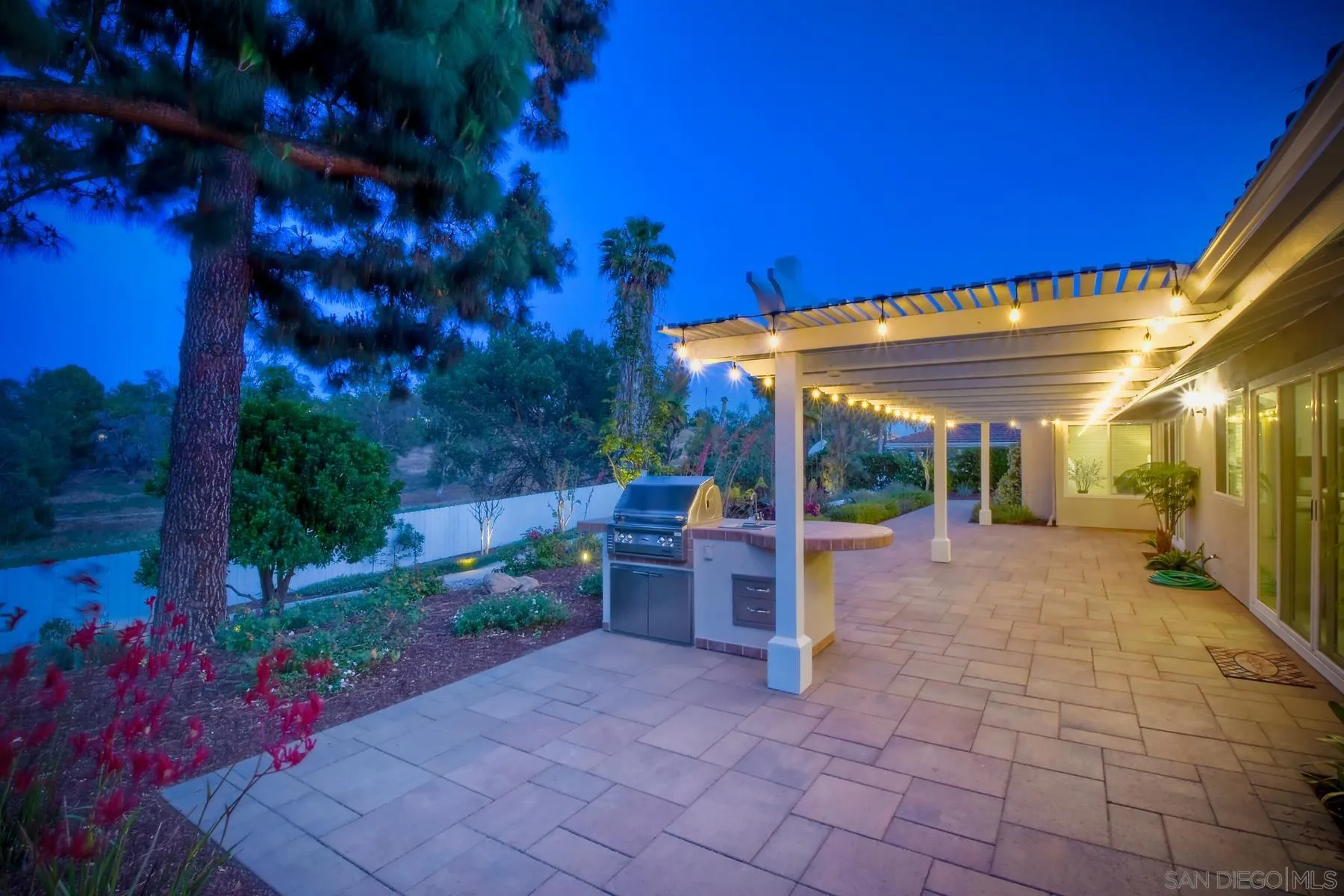 17533 St Andrews Drive Poway, CA 92064 - Photo 33 of 56 a view of a patio with a table and chairs under an umbrella
