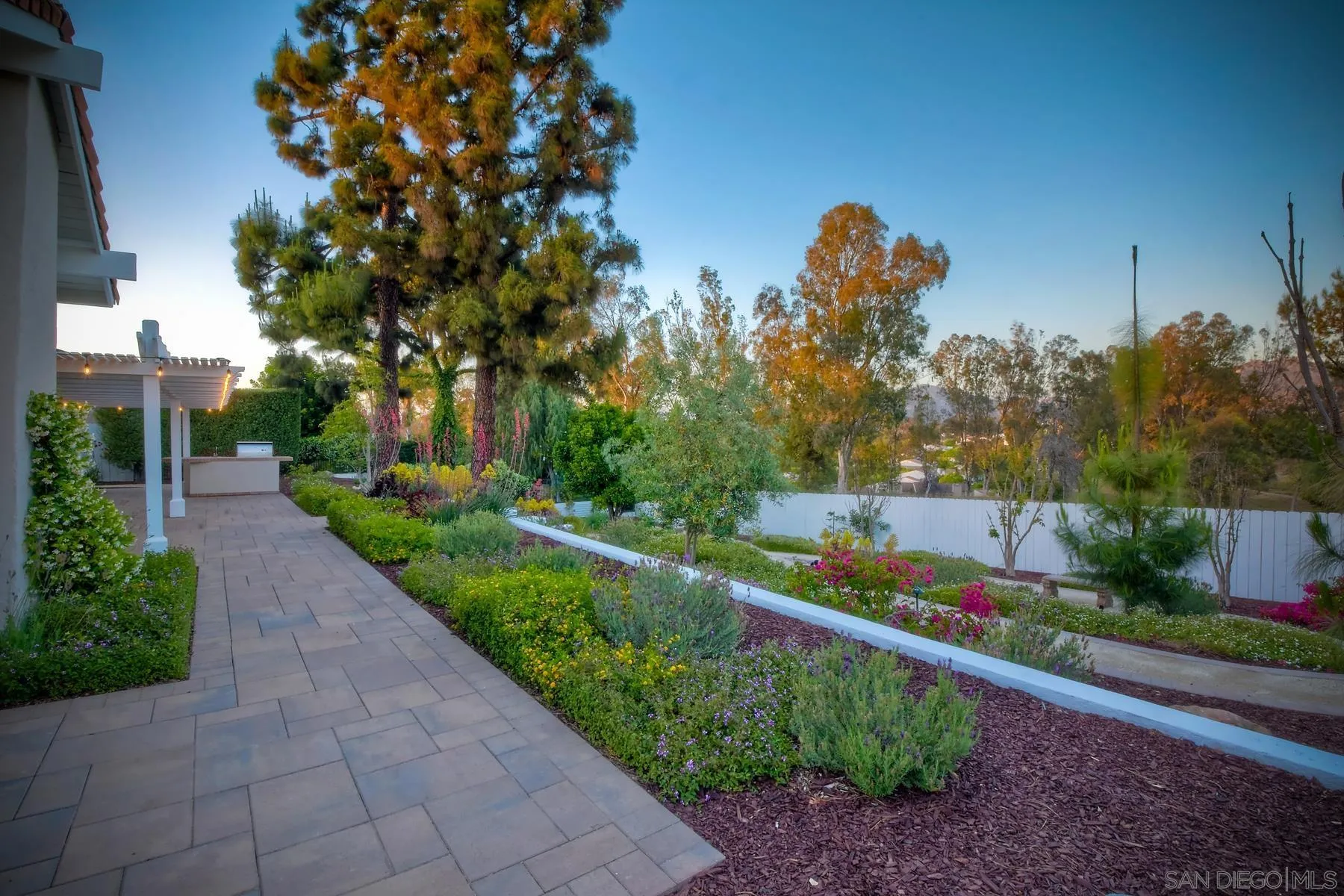 17533 St Andrews Drive Poway, CA 92064 - Photo 40 of 56 a view of a garden with a tree in the background