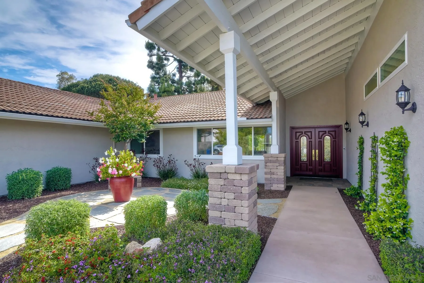 17533 St Andrews Drive Poway, CA 92064 - Photo 4 of 56 a front view of a house with a yard and potted plants