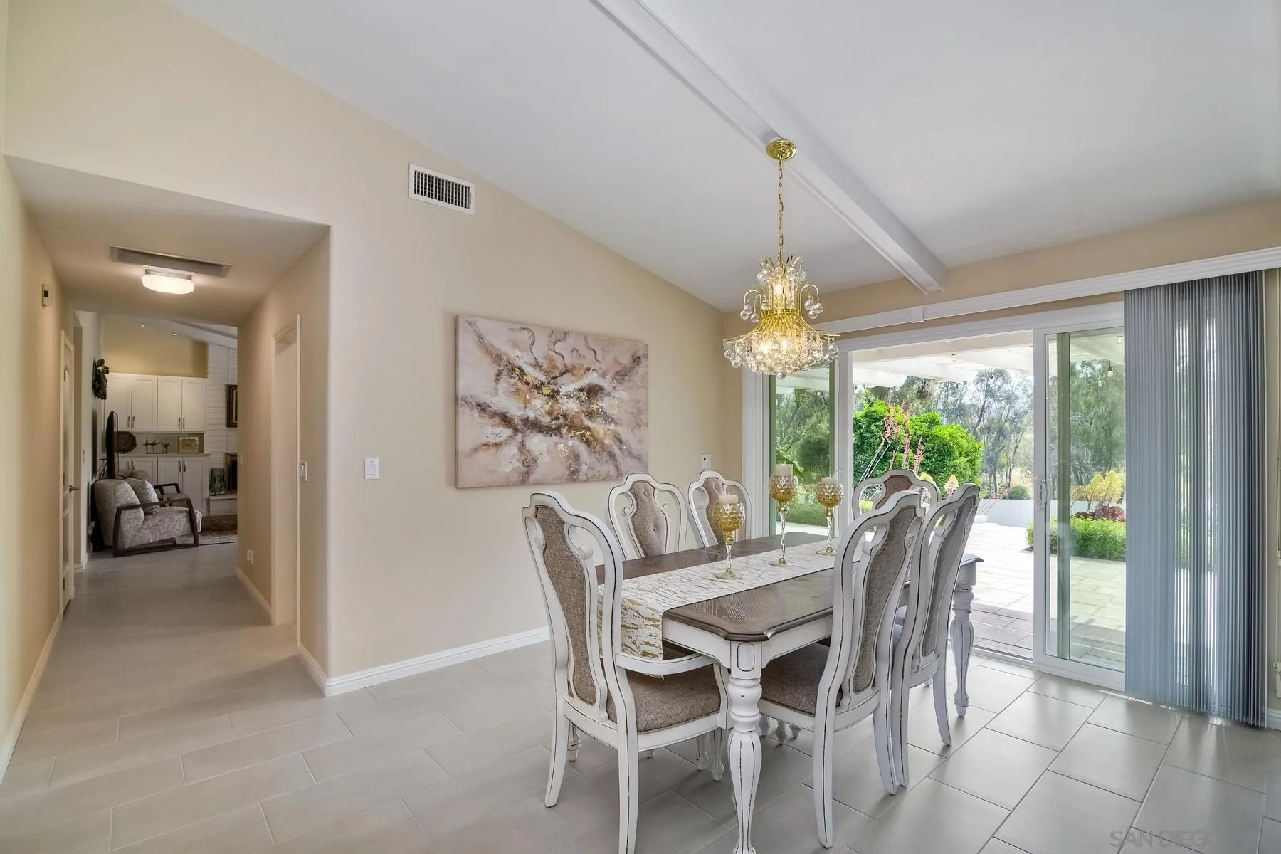 17533 St Andrews Drive Poway, CA 92064 - Photo 9 of 56 a view of a dining room with furniture large window and chandelier