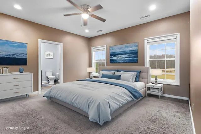 a spacious bedroom with a bed and a dresser