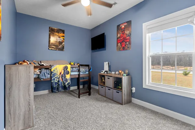 a view of a livingroom with furniture and a flat screen tv