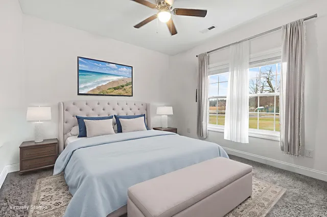 a bedroom with a large bed and a window